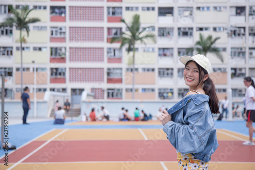 Girl with View of Choi Hung Estate with Colorful rainbow design. It is located in Wong Tai Sin district of Kowloon, Hong Kong. 