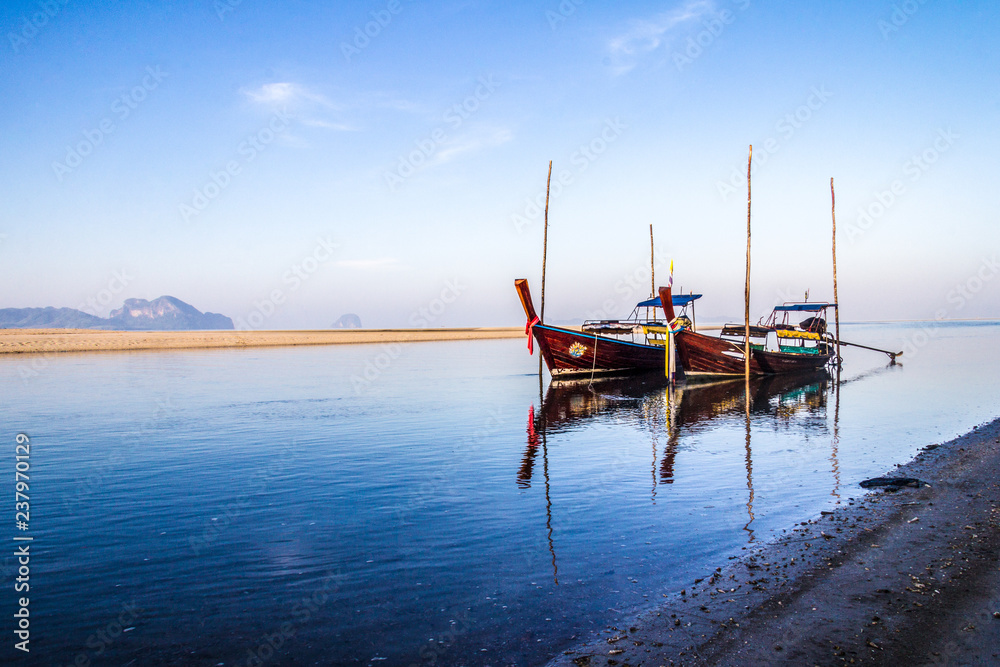 Long tail boats moored in river estuary