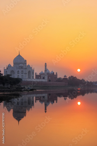 Taj Mahal reflected in Yamuna river at sunset in Agra, India