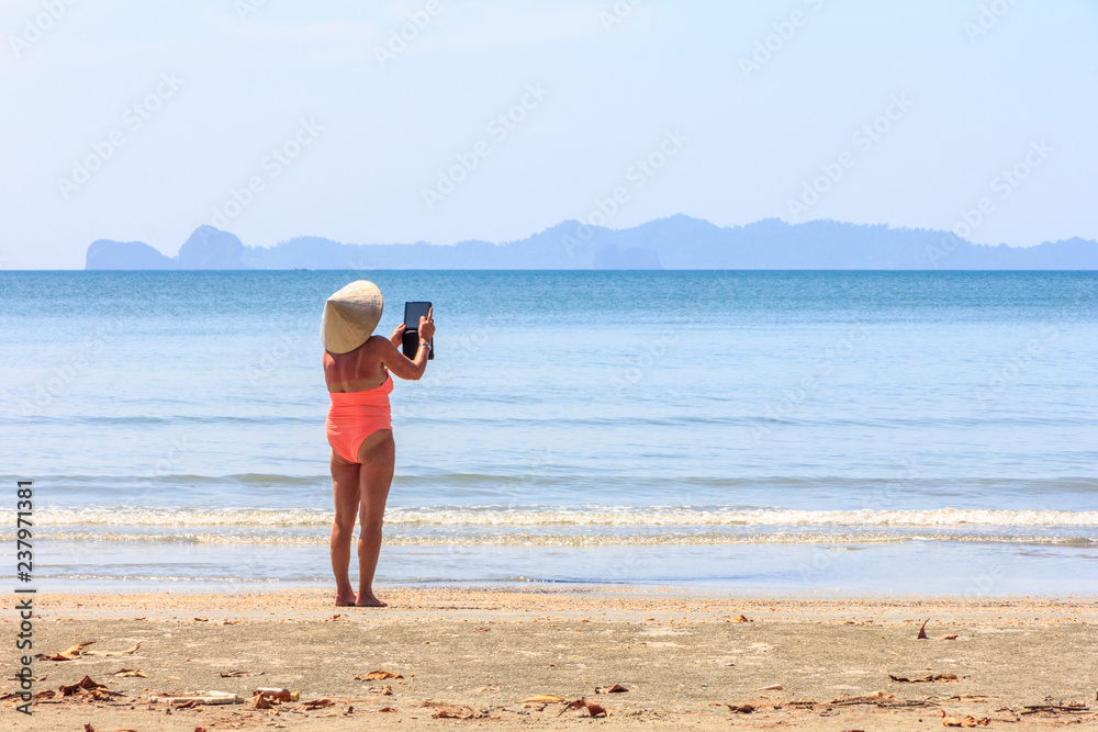 Woman taking photo on Ipad