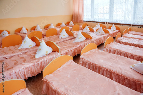 Cots in the kindergarten. Orphanage or boarding school. Beds in a boarding school or in an orphanage photo