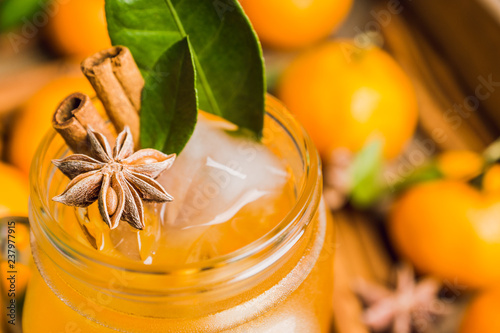 Icy cold mandarin beverage on the rustic background. Selective focus. Shallow depth of field. photo