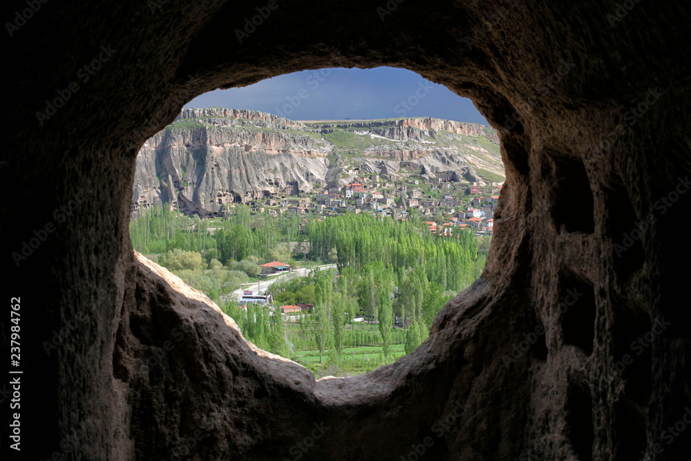 View of a nearby town through a window in the Selime Monastery
