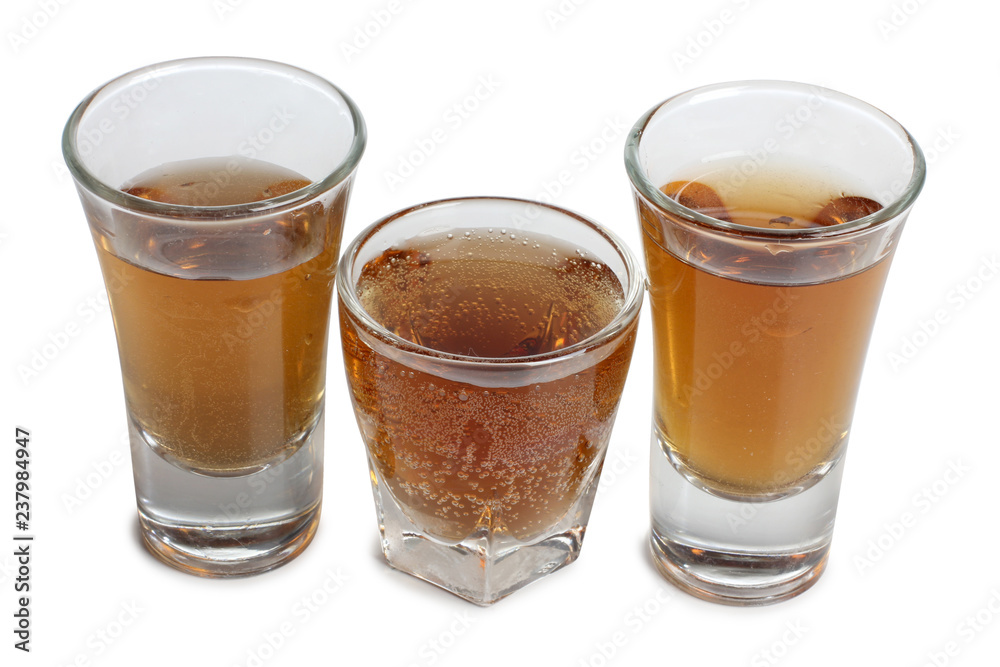 Glass jars with whiskey on white background Glass jars with whiskey on white background