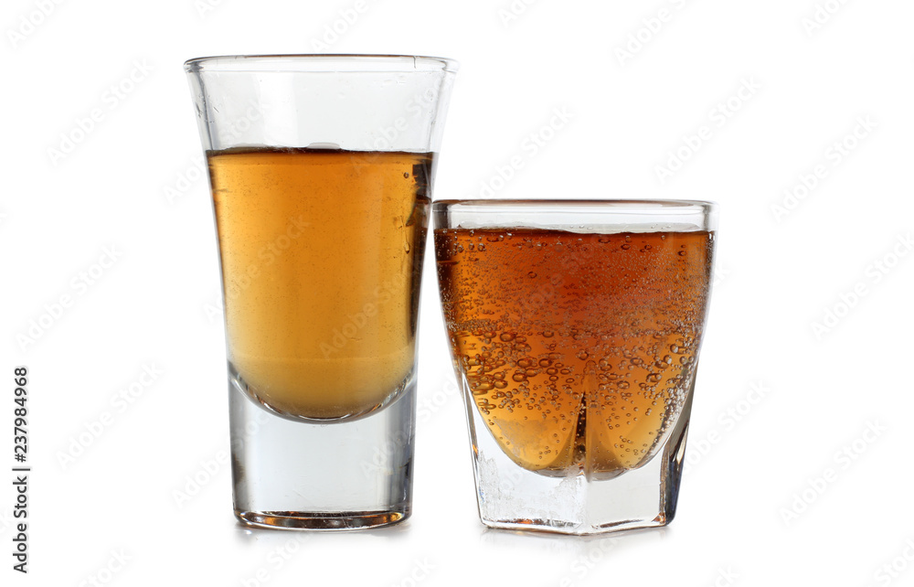 Glass jars with whiskey on white background Glass jars with whiskey on white background