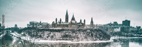 Ottawa Parliament in Winter . Cityscape of Canada's capital city, canadian travel destination in snow landscape. Banner panorama.
