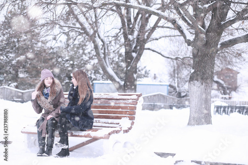 Girl in a winter park in snowfall