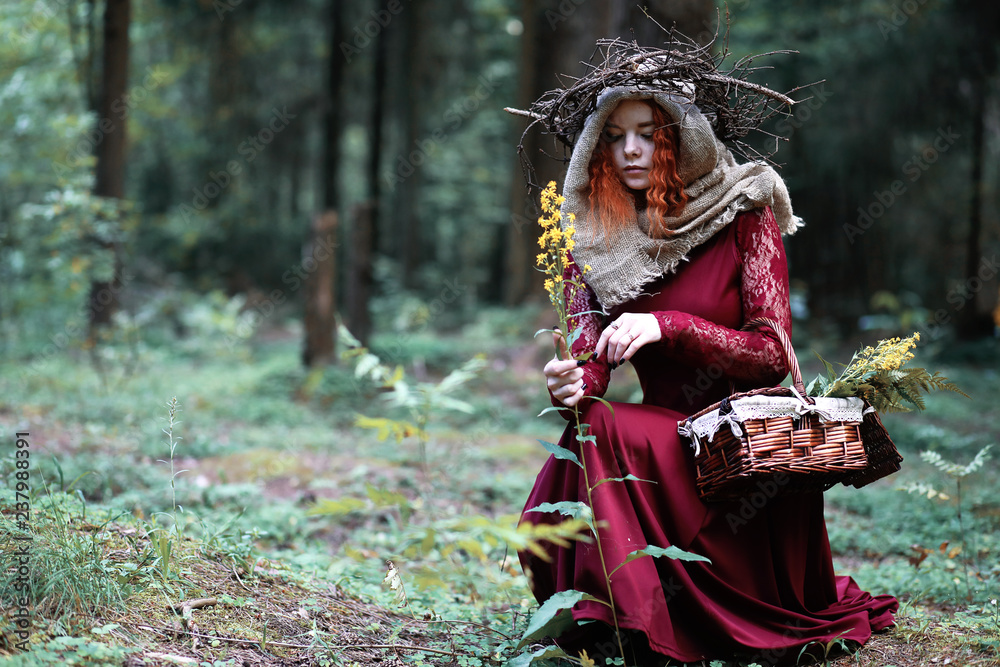 The red-haired witch holds a ritual with a crystal ball The red-haired witch holds a ritual with a crystal ball
