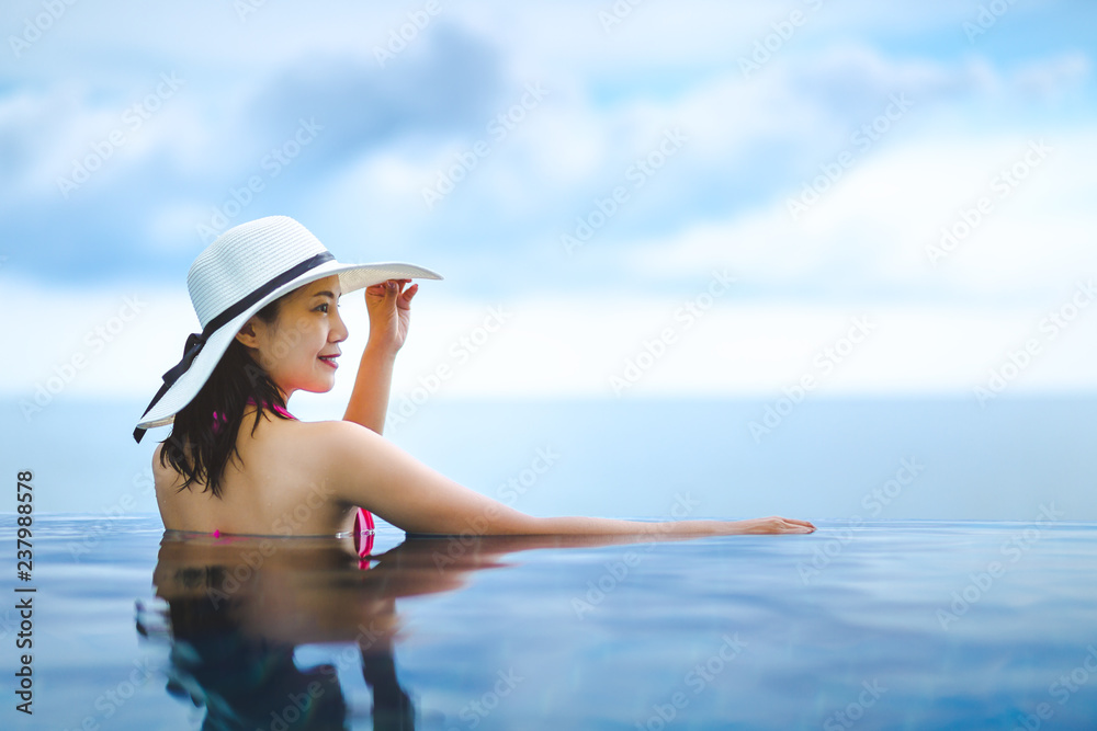 Asian woman relax in pool on beach Asian woman relax in pool on beach