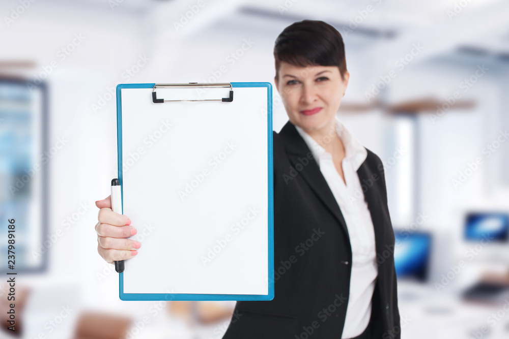 The concept of business, technology, the Internet and the network. Young entrepreneur showing blank clipboard. Success in business, job and education concept shot. The concept of business, technology, the Internet and the network. Young entrepreneur showing blank clipboard. Success in business, job and education concept shot.