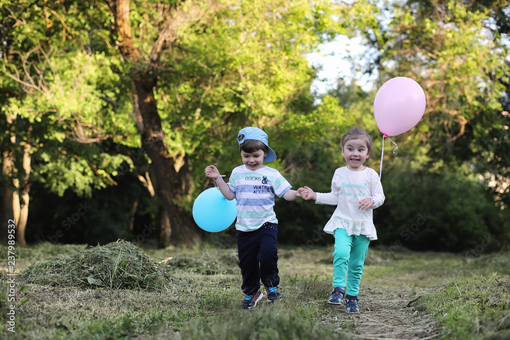 Fototapeta premium Little children are walking in a park