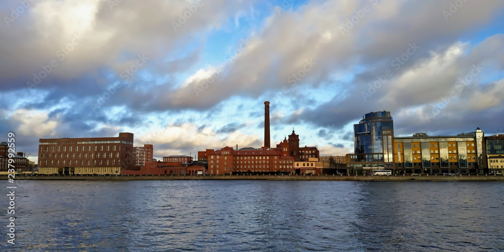 Fototapeta premium Modern high-rise buildings near the city bridge on the river bank