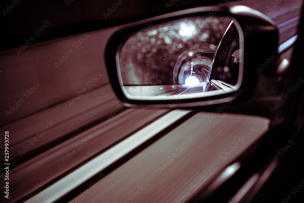 Left mirror car on a dark tunnel