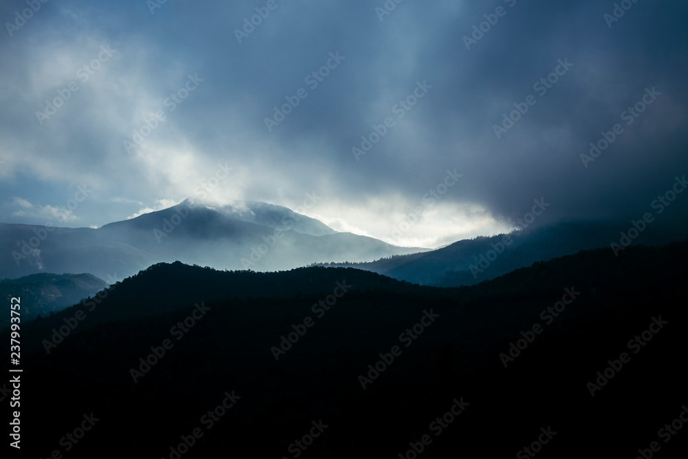 Foggy sunrise cloudscape over a mountain landscape
