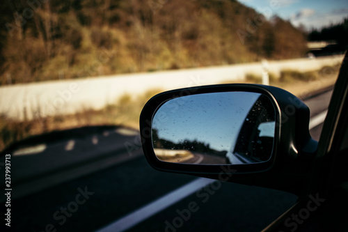 Left mirror car on a highway