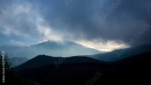 Foggy sunrise cloudscape over a mountain landscape © jordieasy