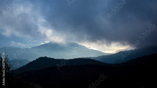 Foggy sunrise cloudscape over a mountain landscape