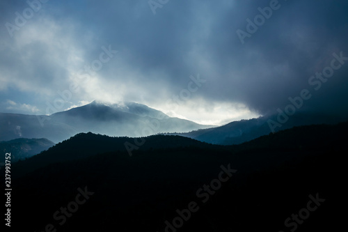 Foggy sunrise cloudscape over a mountain landscape