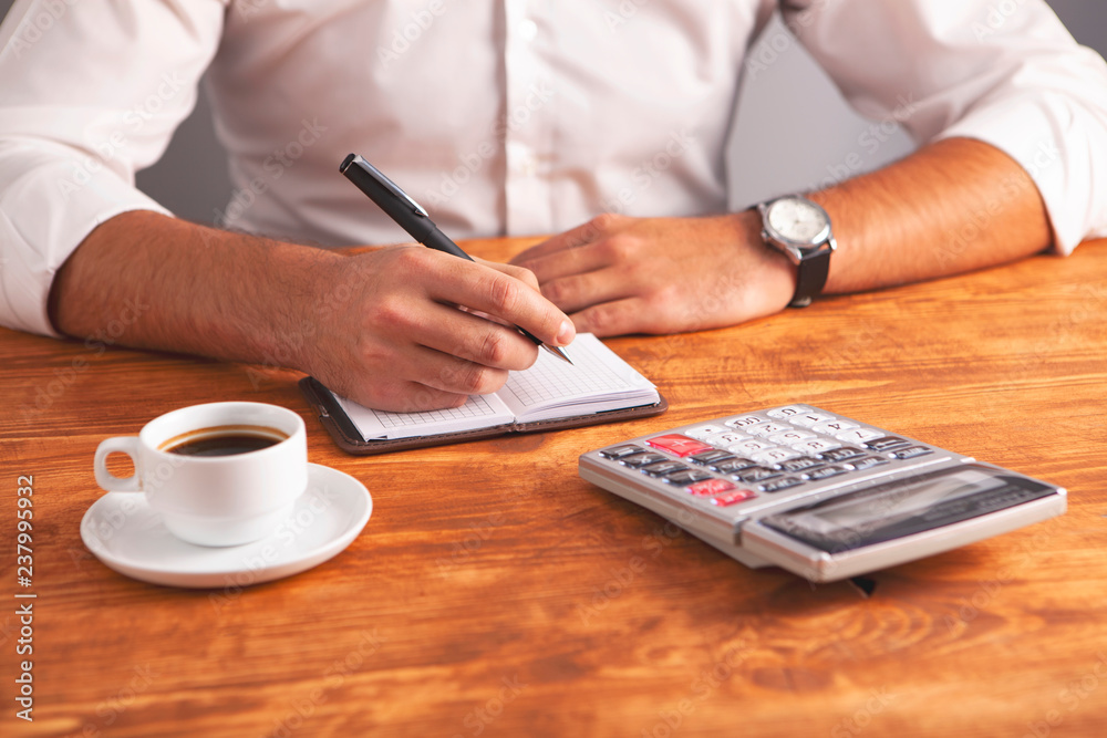 Fototapeta premium businessman coffee calculator notebook