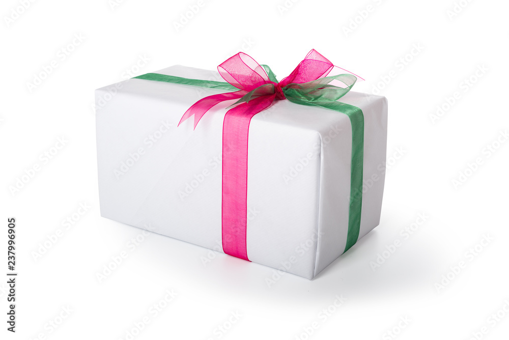 Fototapeta premium Present wrapped in white paper decorated with red and green ribbon. Isolated, clipping path