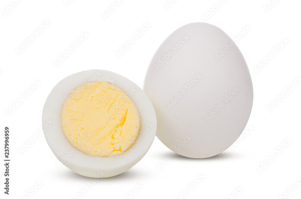 Two boiled whole and sliced eggs isolated on white background