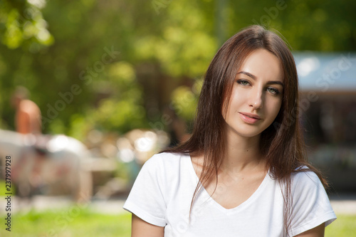 Charming Student Girl Sitting on Green Grass
