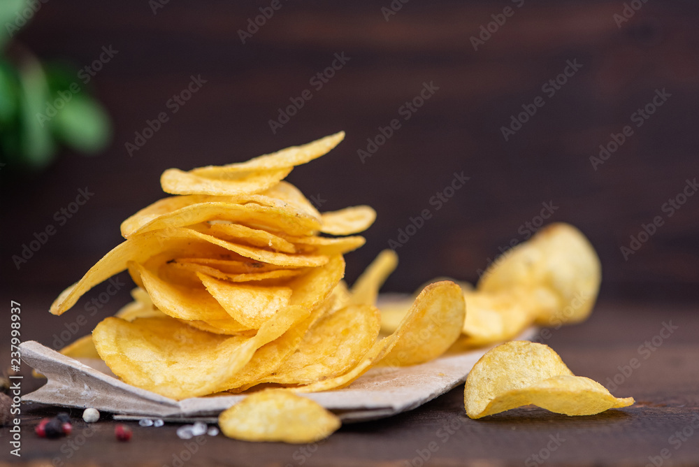 Potato chips in bowl on a wooden background, Selective focus Potato chips in bowl on a wooden background, Selective focus