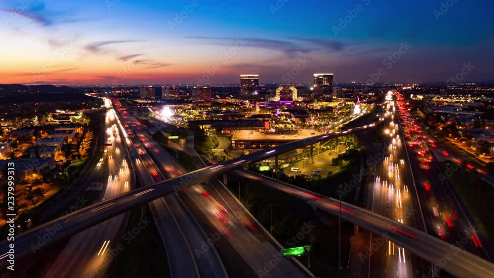 Aerial hyperlapse drone shot of fast moving freeway traffic at night showing cars with light streaks