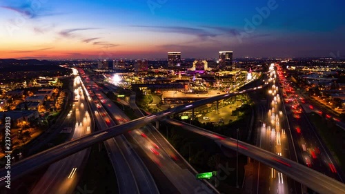 Aerial hyperlapse drone shot of fast moving freeway traffic at night showing cars with light streaks photo