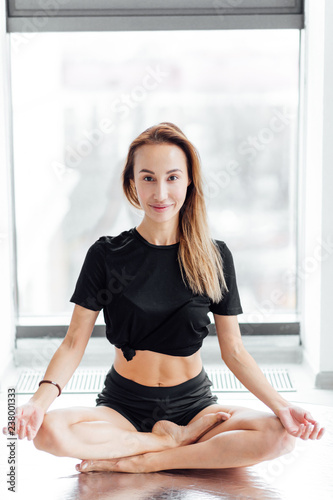joyful female sitting on the floor and looking at the camera. full length photo, girl developing flexibility Free Download joyful female sitting on the floor and looking at the camera. full length photo, girl developing flexibility - GFXLoad