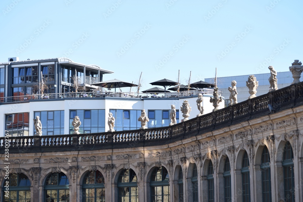 Fototapeta premium Modern versus history - part of the Dresden dungeon in front of a modern building