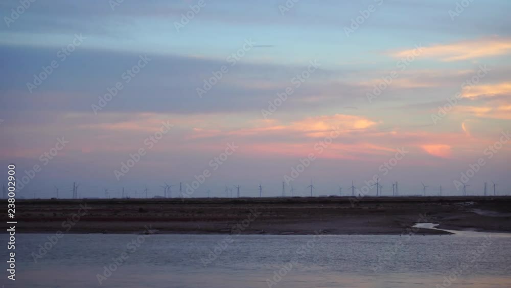 wind power plant on shoal at sunset wind power plant on shoal at sunset