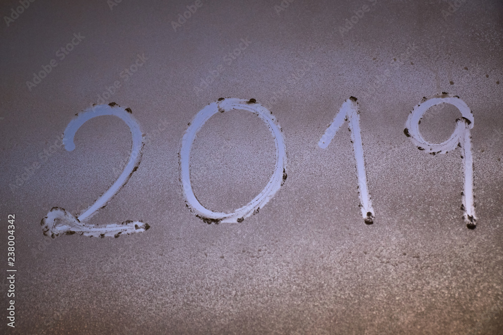 written the number of the new year 2019 on a window with a foam spray written the number of the new year 2019 on a window with a foam spray