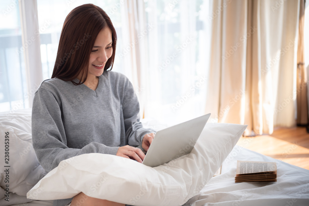 Fototapeta premium Asian Beautiful woman typing on her laptop.