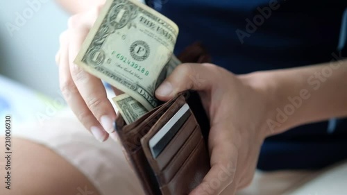 She's shopping and purchase wares who counting dollar cash money, Banknotes for payment. She plan about her appropriate finance. Financial concept and Investment concept.