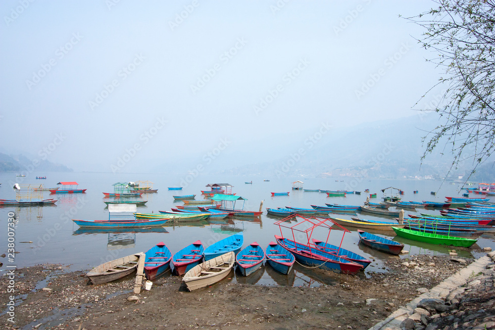 multi-colored boats in Pokhara in Nepal multi-colored boats in Pokhara in Nepal