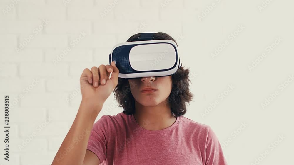 Teenager boy using modern virtual reality glasses at home, 4k Teenager boy using modern virtual reality glasses at home, 4k