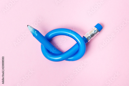 Flexible pencil on pink background. Bent pencils. Flexible business concept. photo