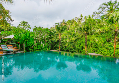infinity pool at tropical luxury resort in Asia with view to the jungle in holidays travel and tourism concept
