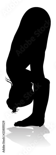 A silhouette of a woman in a yoga or pilates pose 