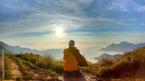 Monk sitdown on the rock with sunset.