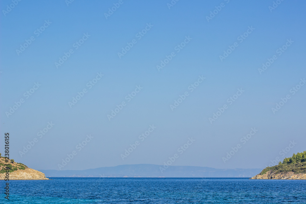 south Mediterranean wallpaper patter  landscape with two symmetry island and sea bay vivid blue water surface and empty sky, copy space, tourist agency and summer vacation holidays concept
