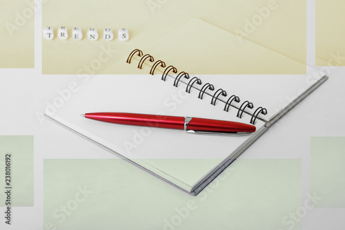 Actual trends. Notepad and pen. Letters on a white surface. Trends - 2019