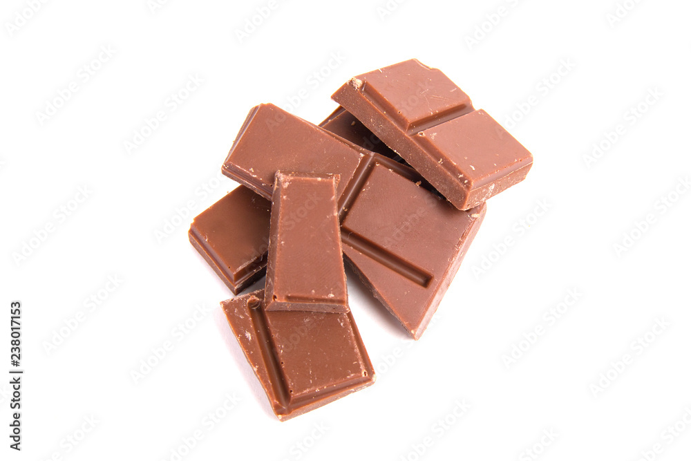 Milk chocolate pieces isolated on white background Milk chocolate pieces isolated on white background