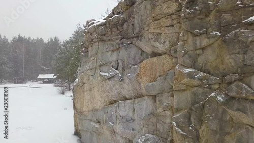 Rocks Korostyshevskogo granite quarry during the winter snowfall. Zhytomyr region. Ukraine
 photo