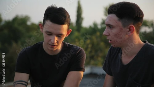 young best friends talking outdoors,sunset,sunlight background