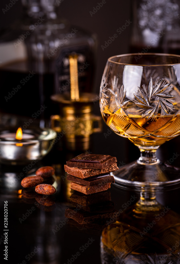 Chocolate with alcohol on dark background Chocolate with alcohol on dark background