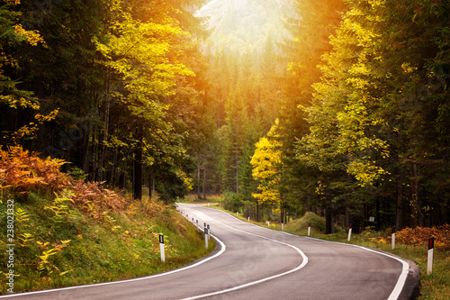 Path to beautiful Dolomites with a nice asphalt road and a beautiful autumn morning.