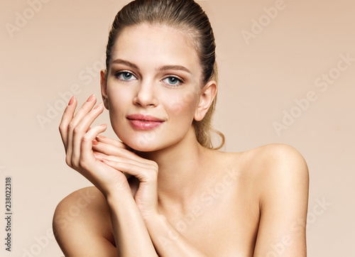 Beautiful girl with flawless skin on beige background. Youth and skin care concept