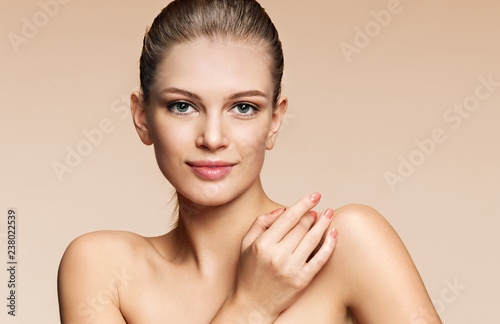 Young girl with perfect skin on beige background. Beauty & Skin care concept